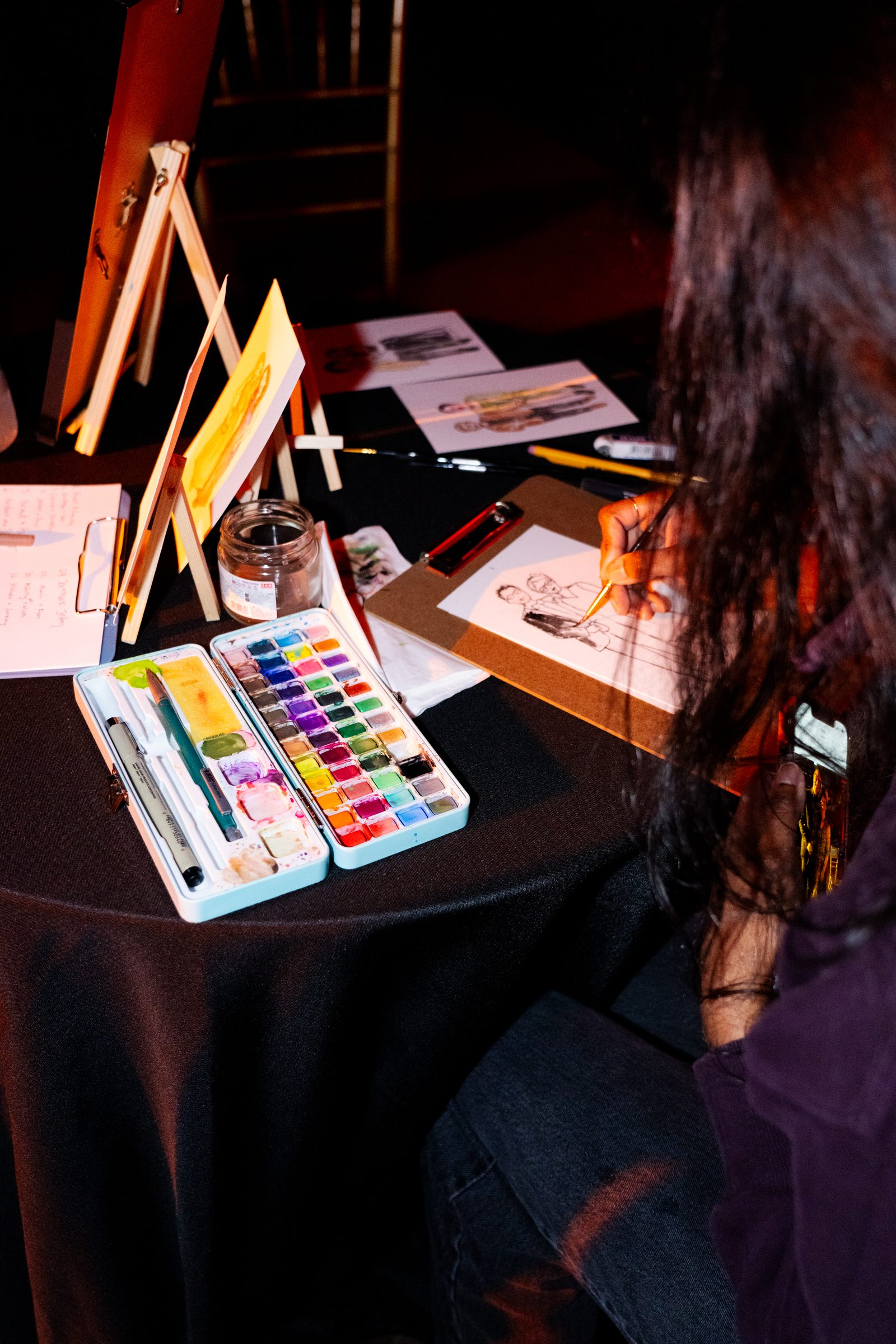 Live painter sketching a guest portrait