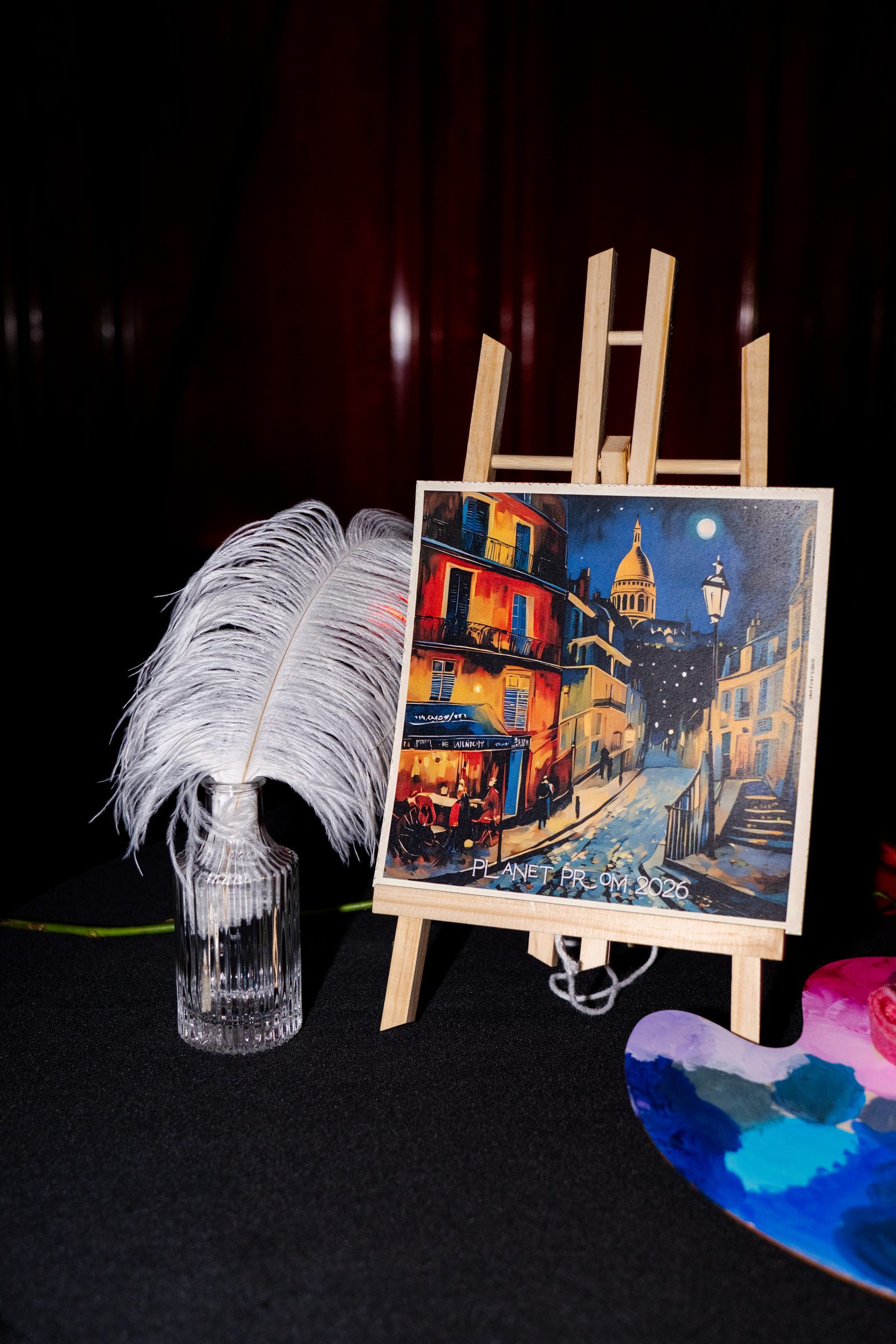 Montmartre painting display with feather accents